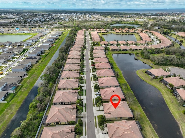 birds eye view of property with a water view and a residential view