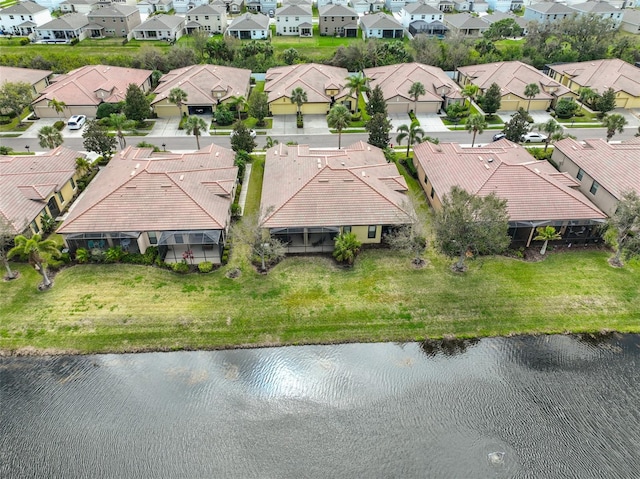 drone / aerial view with a water view and a residential view