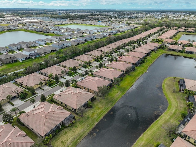 birds eye view of property featuring a water view and a residential view