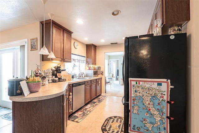 kitchen with stainless steel appliances, recessed lighting, light countertops, visible vents, and a sink