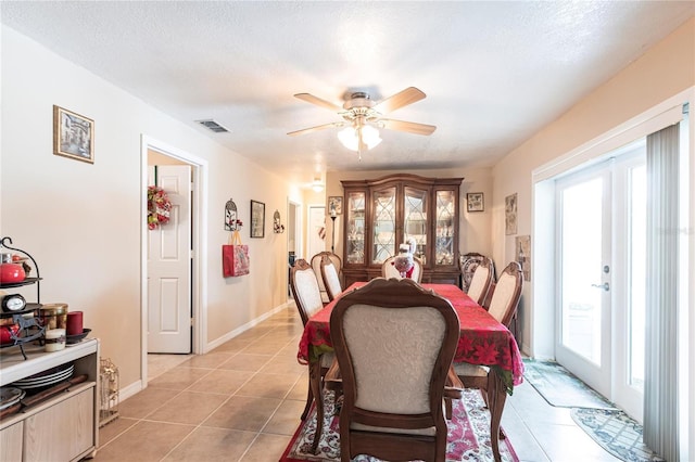 dining room featuring light tile patterned floors, visible vents, ceiling fan, a textured ceiling, and french doors