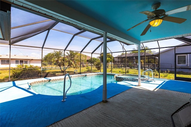 view of pool with a patio, glass enclosure, and a pool with connected hot tub