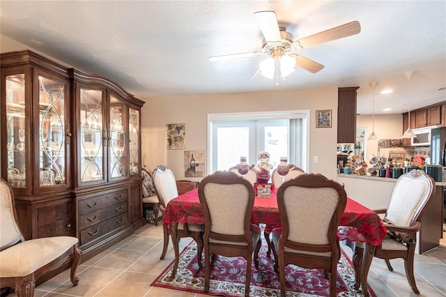 dining area with a ceiling fan, french doors, a textured ceiling, and light tile patterned floors