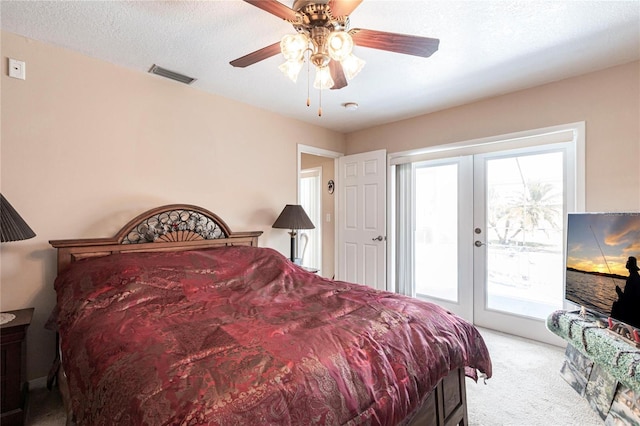 bedroom featuring access to exterior, french doors, visible vents, light carpet, and multiple windows