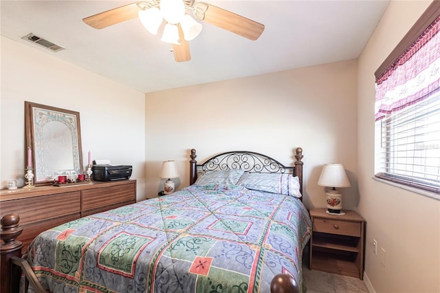 bedroom featuring baseboards, visible vents, and a ceiling fan