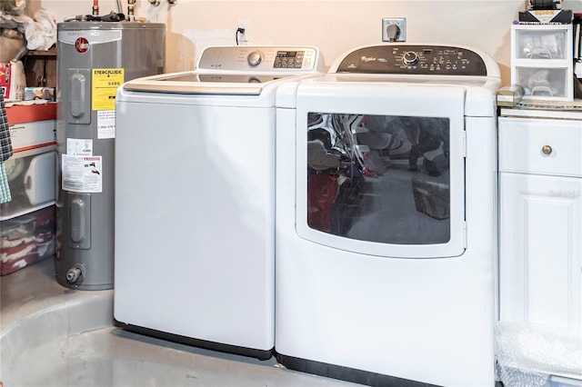 clothes washing area featuring washer and clothes dryer and electric water heater