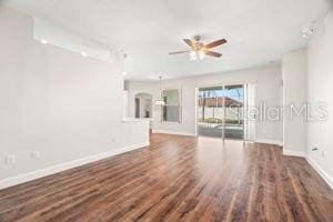 spare room with ceiling fan, baseboards, and wood finished floors