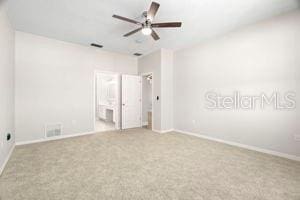 unfurnished bedroom with carpet floors, visible vents, and baseboards