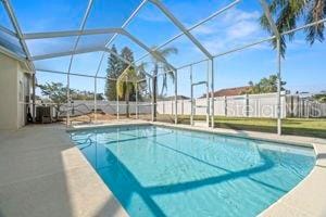 view of swimming pool featuring a patio, a lanai, and a fenced in pool