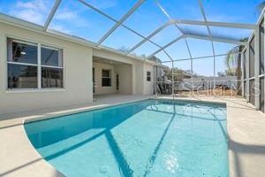 pool with a lanai and a patio area