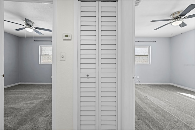 room details with carpet, a textured ceiling, baseboards, and a ceiling fan