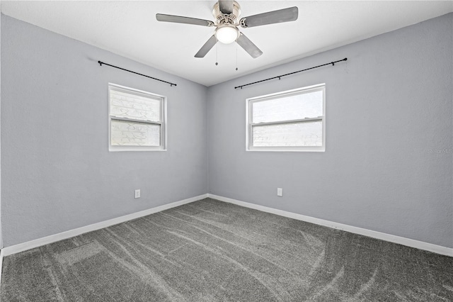 empty room with baseboards, carpet flooring, a ceiling fan, and a healthy amount of sunlight