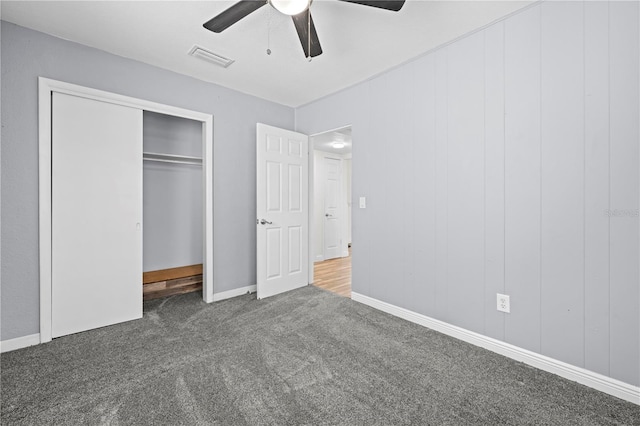 unfurnished bedroom with carpet floors, ceiling fan, visible vents, and a closet