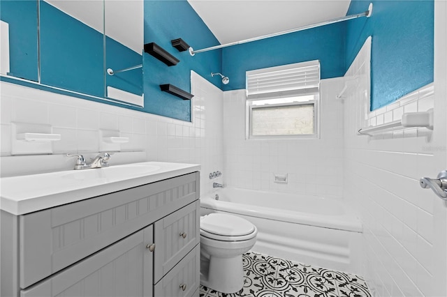 full bathroom featuring toilet, tile patterned flooring, bathtub / shower combination, vanity, and tile walls