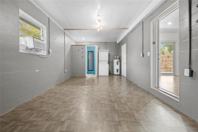 interior space featuring concrete block wall and electric water heater