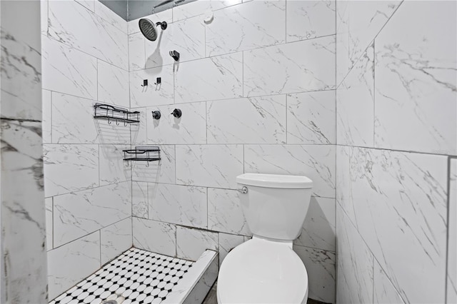 bathroom with tiled shower and toilet