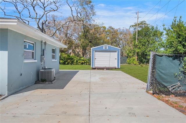 view of patio with a storage shed, fence, central AC, and an outdoor structure