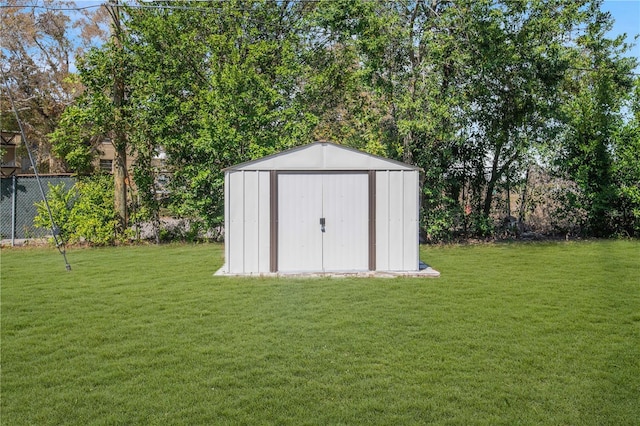 view of shed featuring fence