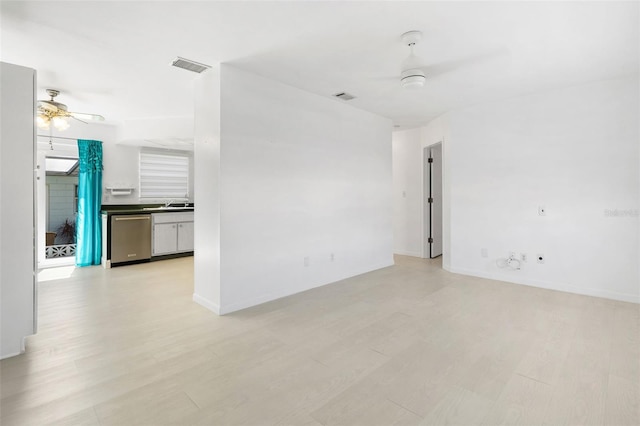 spare room featuring a ceiling fan, baseboards, visible vents, and light wood finished floors