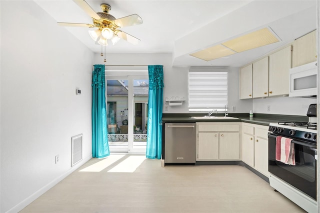 kitchen featuring range with gas stovetop, dark countertops, visible vents, stainless steel dishwasher, and white microwave