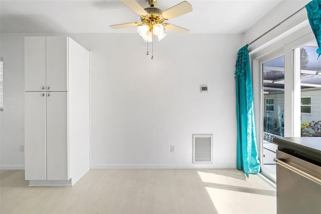 unfurnished dining area featuring a ceiling fan, light wood-type flooring, visible vents, and baseboards