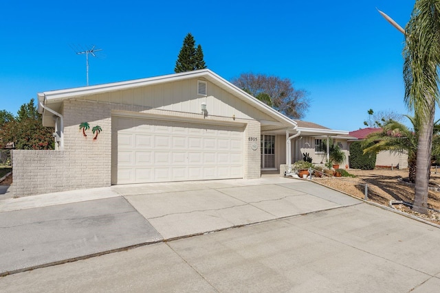 ranch-style house with a garage, brick siding, and driveway