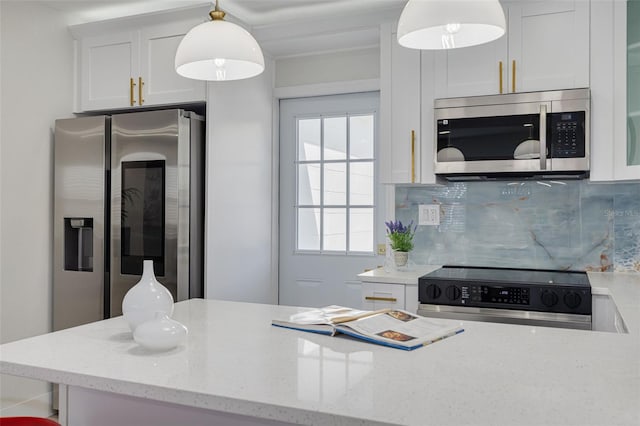 kitchen featuring light stone counters, pendant lighting, stainless steel appliances, backsplash, and white cabinets