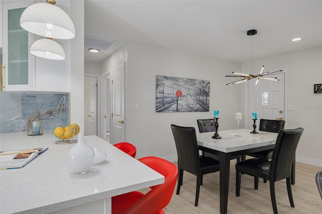 dining room with light wood finished floors and baseboards