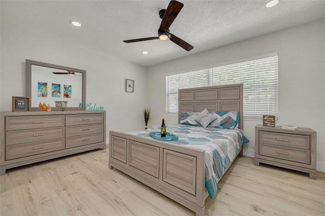 bedroom featuring a textured ceiling, ceiling fan, recessed lighting, and light wood-style floors