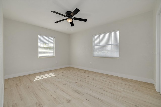 unfurnished room featuring ceiling fan, baseboards, and wood finished floors