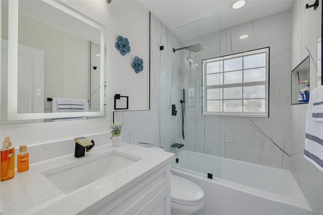 bathroom featuring toilet, washtub / shower combination, and vanity