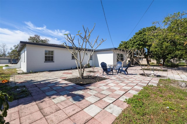 back of property featuring a patio