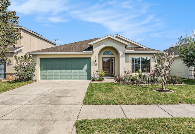 single story home with an attached garage, a front lawn, and stucco siding