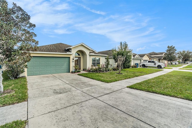 single story home featuring driveway, an attached garage, a front lawn, and stucco siding