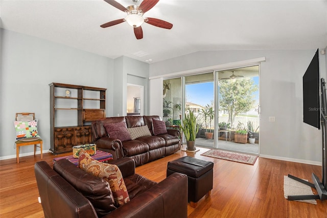 living room with lofted ceiling, ceiling fan, wood finished floors, and baseboards