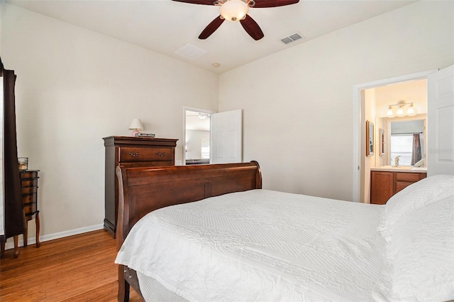 bedroom with light wood finished floors, baseboards, visible vents, ceiling fan, and ensuite bathroom