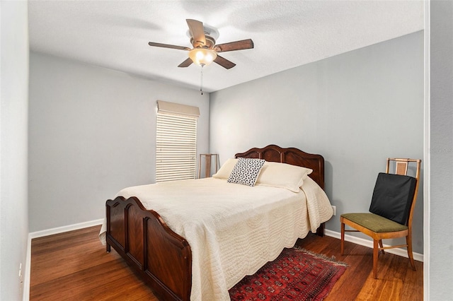 bedroom featuring ceiling fan, baseboards, and dark wood-style flooring