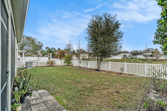 view of yard featuring cooling unit, a fenced backyard, and a residential view