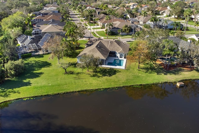 drone / aerial view featuring a water view and a residential view