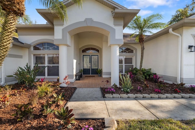 entrance to property with french doors and stucco siding