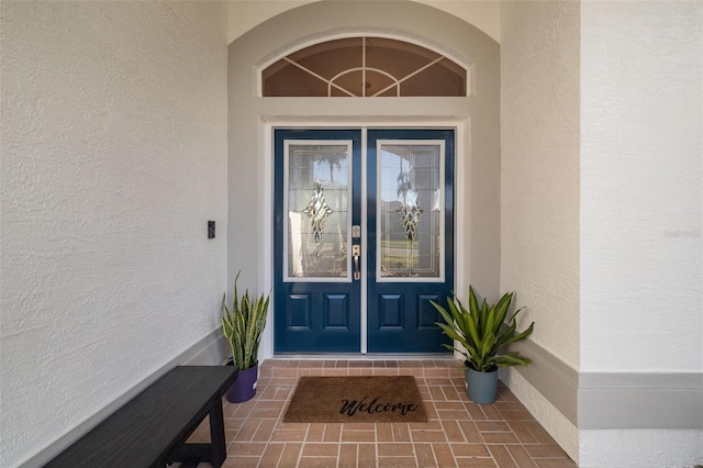 view of exterior entry with stucco siding