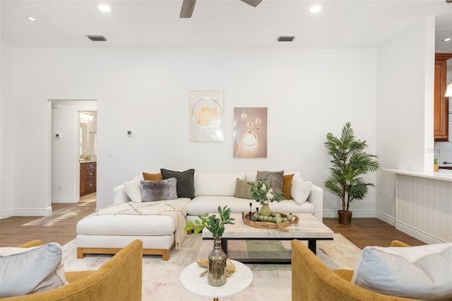 living area featuring ceiling fan, recessed lighting, wood finished floors, visible vents, and baseboards