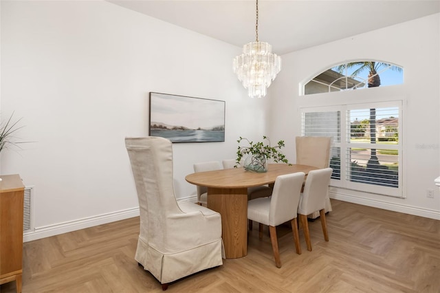 dining space featuring a chandelier, visible vents, and baseboards