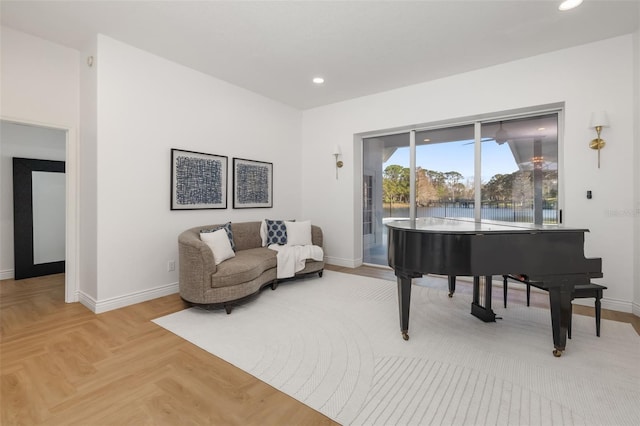 sitting room featuring baseboards and recessed lighting