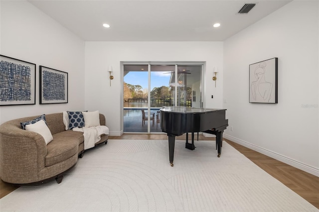 sitting room with baseboards, visible vents, and recessed lighting