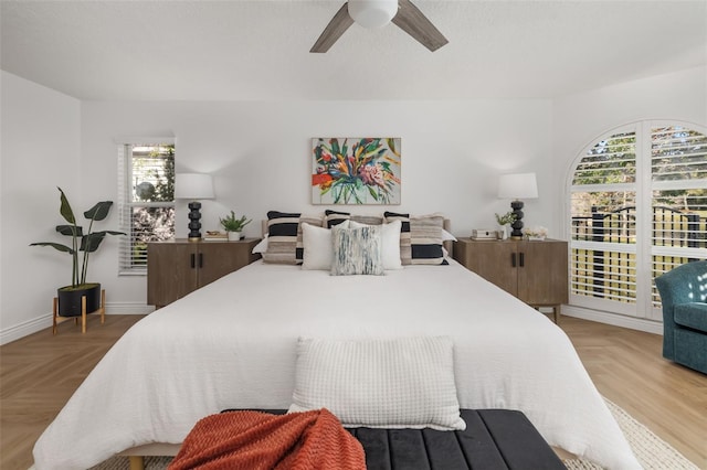 bedroom with a ceiling fan and baseboards