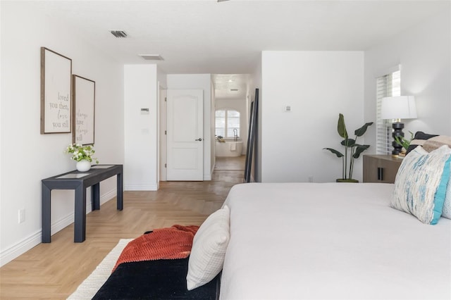 bedroom featuring visible vents and baseboards