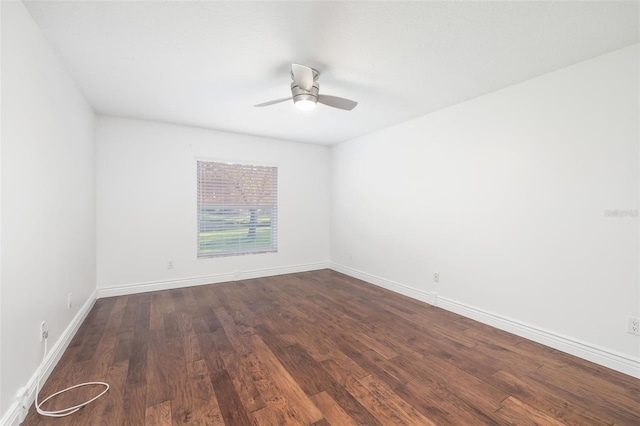 empty room featuring wood finished floors, a ceiling fan, and baseboards