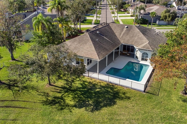 view of pool featuring a fenced in pool, a lawn, a sunroom, a patio area, and fence private yard