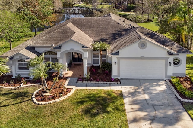 view of front of property with a garage, driveway, a front yard, and stucco siding